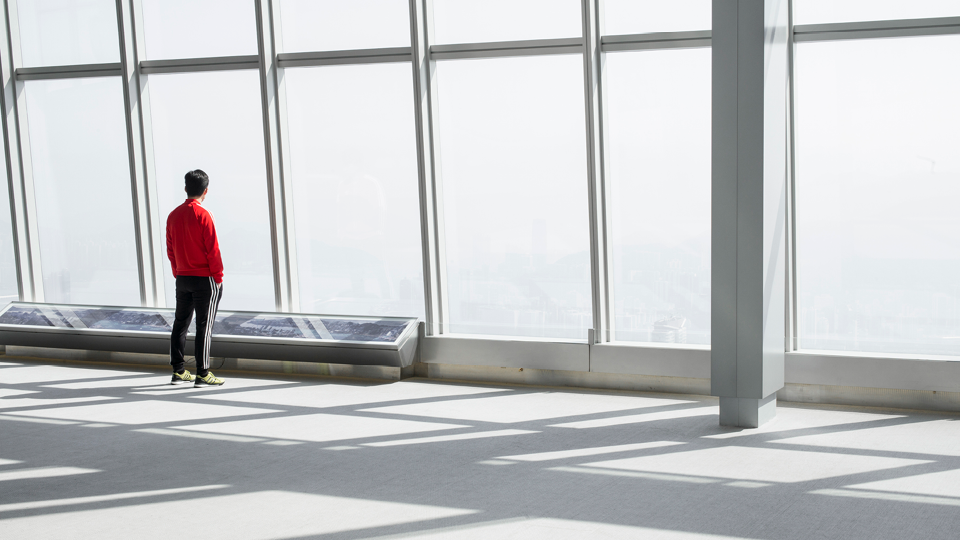 Man looking out of building